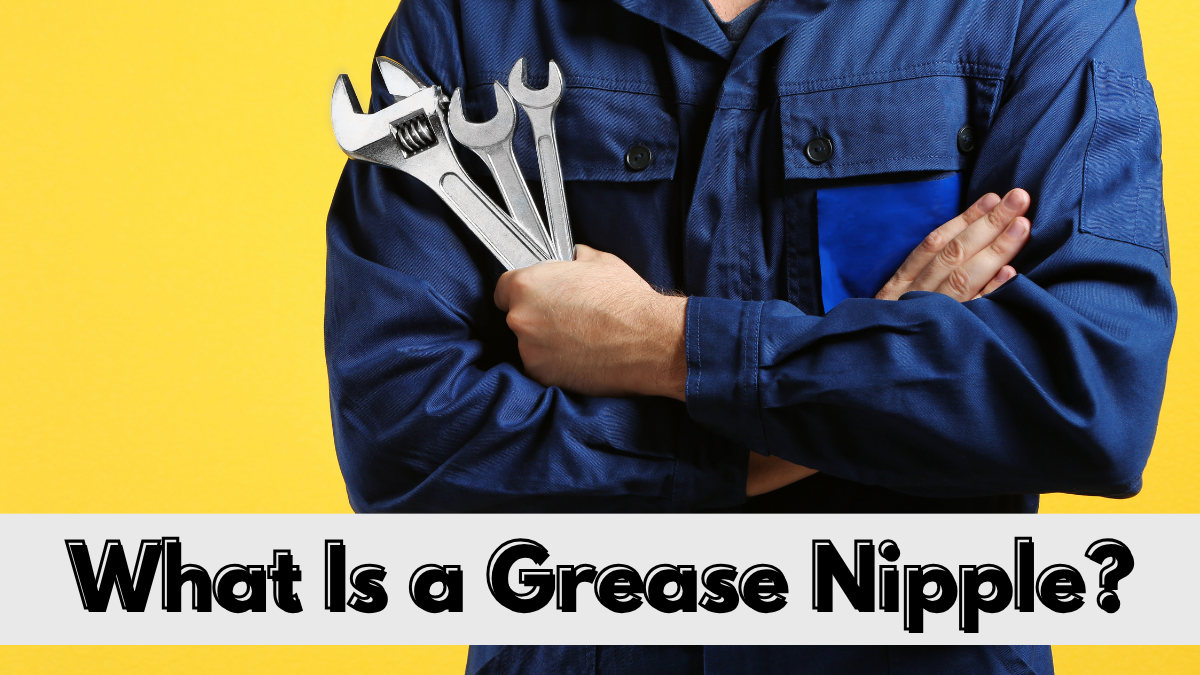 A mechanic in blue overalls holding spanners, with a banner reading: what is a grease nipple?