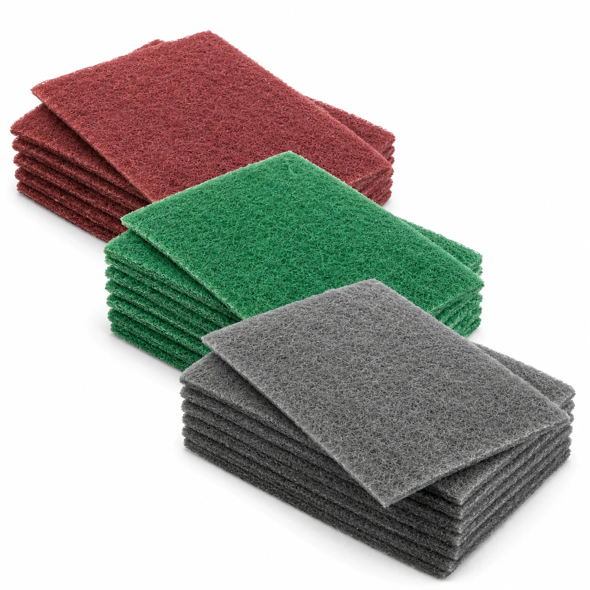Three stacks of rectangular `sandpaper hand pads in red, green, and gray, arranged diagonally on a white background.